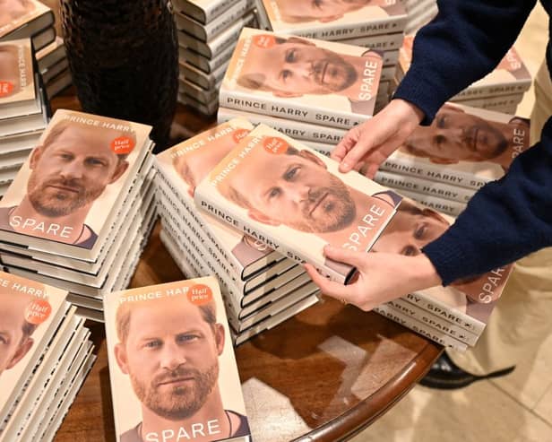 Prince Harry Spare: When does it come out in paperback and are there any new additions? A bookseller holds a copy of "Spare" by Britain's Prince Harry, Duke of Sussex, at Waterstones' flagship Piccadilly bookshop on the day of its release in London, on January 10, 2023