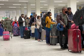 Passengers queue for check in at Manchester Airport's Terminal 1