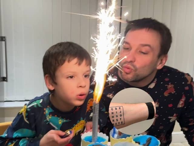 Non-verbal autistic boy communicates using dad's alphabet tattoo