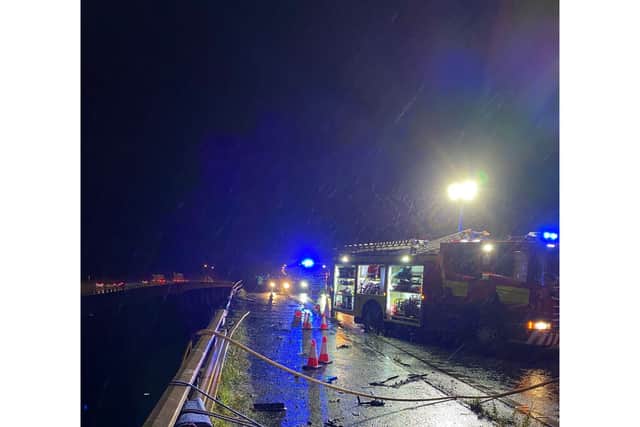 Cheshire Fire and Rescue Service handout photo of emergency services on the scene under a bridge on the M6 in Cheshire where a lorry fell 60 metres from the Thelwall Viaduct between junctions 20 and 21, landing on the embankment below. Issue date: Monday September 30, 2024.