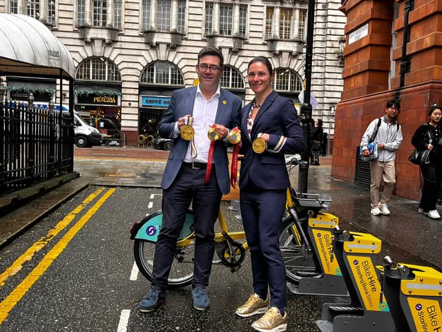 Mayor Andy Burnham and Dame Sarah Storey, wearing gold trainers to match her gold medals