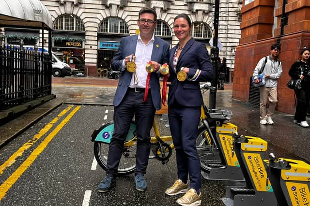 Mayor Andy Burnham and Dame Sarah Storey, wearing gold trainers to match her gold medals