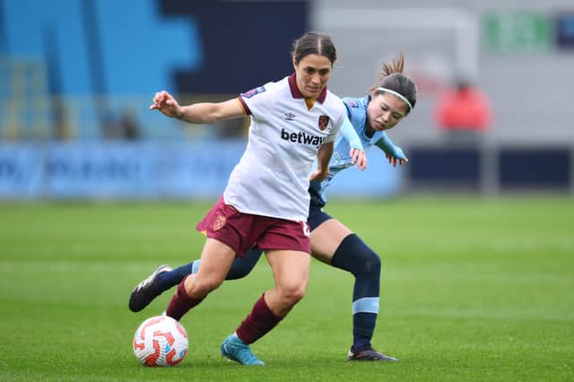 The influential Yui Hasegawa challenges West Ham' Kirsty Smith.