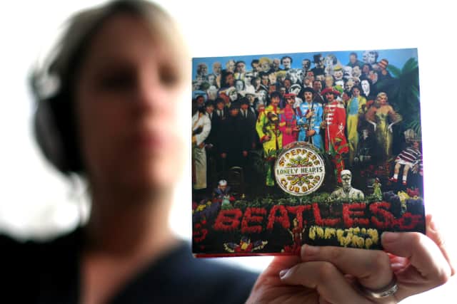 A copy of The Beatles "Sgt Peppers Lonely Hearts Club Band" album is held by a listener; the album cover suggested several clues as to Sir Paul McCartney's "death."