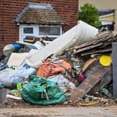 Horrified residents are demanding action after their neighbours turned their home into a makeshift TIP with tonnes of rubbish dumped on the driveway.  