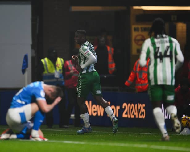 Richard Kone scores Wycombe's third in their 5-0 win at Stockport. 
