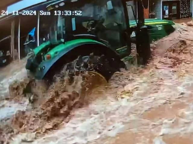 CCTV captures a tractor driving fast through floodwater in Tenbury Wells, Worcestershire.