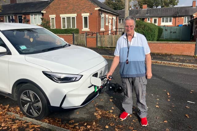 David Kelsall next to his EV. Credit: Charlotte Hall / LDRS.
