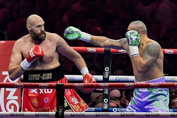 Britain's Tyson Fury (red) and Ukraine's Oleksandr Usyk (blue) compete during their heavyweight world championship rematch on December 22, 2024. Credit: AFP via Getty Images)