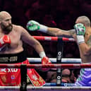 Britain's Tyson Fury (red) and Ukraine's Oleksandr Usyk (blue) compete during their heavyweight world championship rematch on December 22, 2024. Credit: AFP via Getty Images)