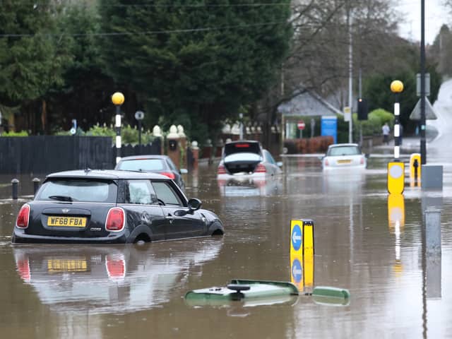 Cars stranded in deep water due to flooding in Stockport.