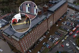 Car are flooded outside a newly converted Meadow Mill on Water street in Stockport as emergency teams arrive to rescue people trapped inside. January 1 2025.
