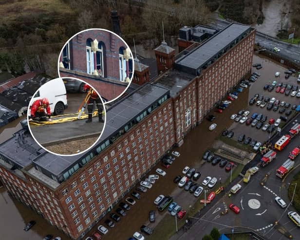Car are flooded outside a newly converted Meadow Mill on Water street in Stockport as emergency teams arrive to rescue people trapped inside. January 1 2025.