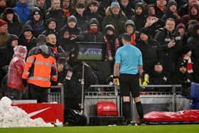 Referee Michael Oliver refers to the on-field VAR screen to review and subsequently award a penalty after Matthijs de Ligt (not pictured) commits handball during the Premier League match between Liverpool FC and Manchester United FC at Anfield on January 05, 2025 in Liverpool, England.