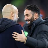Pep Guardiola, Manager of Manchester City, and Ruben Amorim, Manager of Manchester United, interact prior to the Premier League match between Manchester City FC and Manchester United FC at Etihad Stadium on December 15, 2024 in Manchester, England.