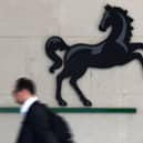 A man passes the entrance to a Lloyds Banking Group office in the City of London (Photo: JUSTIN TALLIS/AFP via Getty Images)