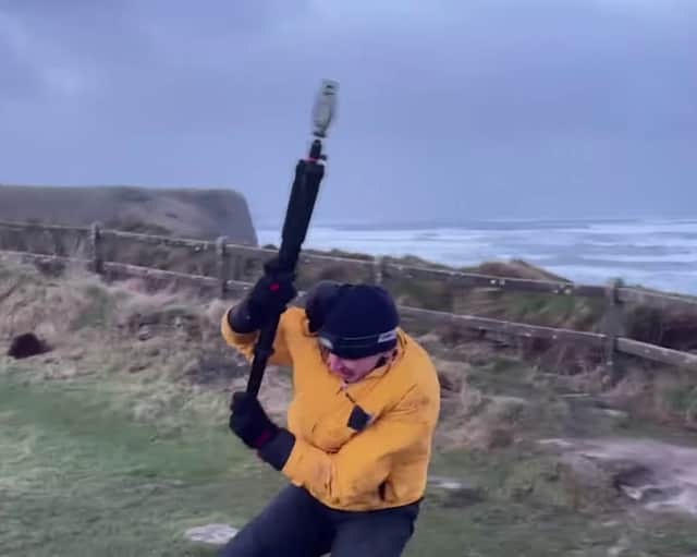 Video taken by the weather tracking group shows their team member battling against the strong winds while attempting to measure the wind speed.