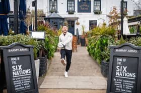 Former England rugby international Danny Care kicking a ball "into space" from outside the Greene King sport pub The Barmy Arms in Twickenham