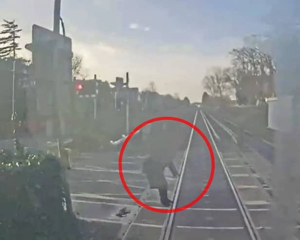Woman comes within ‘half a second’ of being struck by train at level crossing.