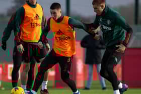 Jonny Evans, Dan Gore, Rhys Bennett of Manchester United in action during a first team training session at Carrington Training Ground on December 21, 2023 in Manchester, England.