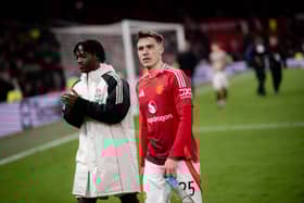 Manuel Ugarte and Kobbie Mainoo of Manchester United applaud the fans after the Emirates FA Cup Fourth Round match between Manchester United and Leicester City at Old Trafford on February 07, 2025 in Manchester, England. 