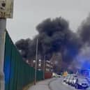 Thick black smoke billows into Manchester sky from HGVs fire.