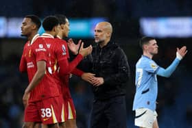 Pep Guardiola, Manager of Manchester City, shakes hands with Virgil van Dijk of Liverpool after the Premier League match between Manchester City FC and Liverpool FC at Etihad Stadium on February 23, 2025 in Manchester, England. 