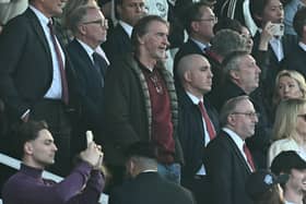 Manchester United's co-owner Jim Ratcliffe (C) takes his seat for the English Premier League football match between Manchester United and Arsenal at Old Trafford in Manchester, north west England, on March 9, 2025. 