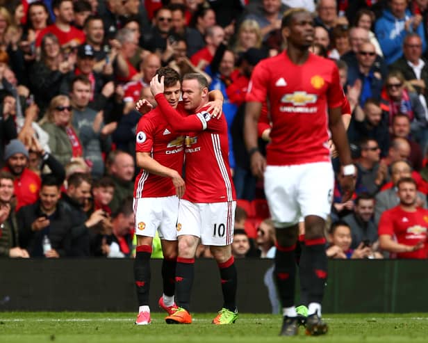 Josh Harrop of Manchester United celebrates scoring his sides first goal with Wayne Rooney of Manchester United during the Premier League match between Manchester United and Crystal Palace at Old Trafford on May 21, 2017 in Manchester, England. 
