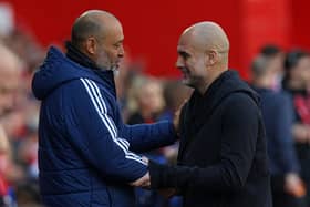 Nottingham Forest's Portuguese manager Nuno Espirito Santo (L) greets Manchester City's Spanish manager Pep Guardiola (R) ahead of kick-off in the English Premier League football match between Nottingham Forest and Manchester City.