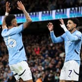 Omar Marmoush of Manchester City celebrates scoring his team's second goal with teammates Jack Grealish and Savinho during the Premier League match between Manchester City FC and Leicester City FC at Etihad Stadium on April 02, 2025 in Manchester, England. 