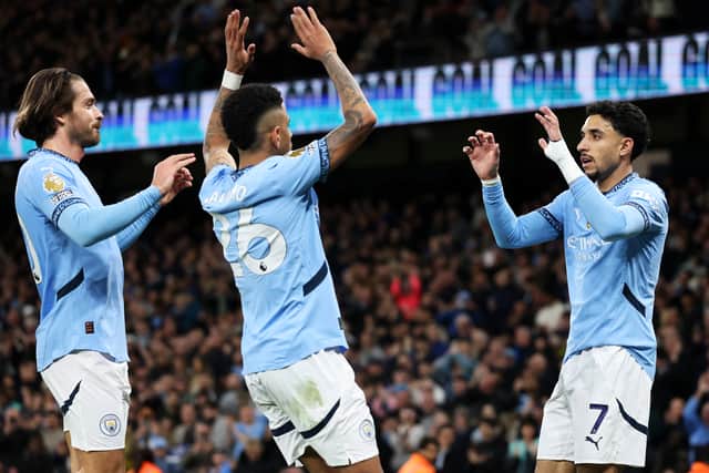 Omar Marmoush of Manchester City celebrates scoring his team's second goal with teammates Jack Grealish and Savinho during the Premier League match between Manchester City FC and Leicester City FC at Etihad Stadium on April 02, 2025 in Manchester, England. 
