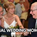 A couple on their wedding day clasping hands with the bride's father