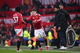 Alejandro Garnacho of Manchester United interacts with teammate Kobbie Mainoo, as he enters the pitch during the Premier League match between Manchester United FC and Brighton & Hove Albion FC at Old Trafford on January 19, 2025 in Manchester, England.