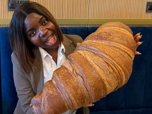 Emmanuella Okpoko with the massive croissant at P&D Gran Caffè in Liverpool.