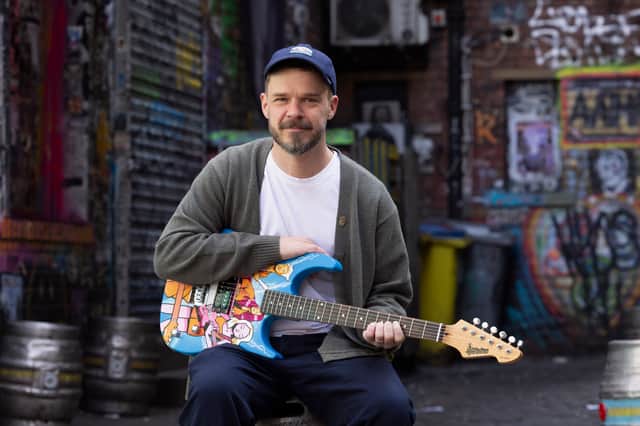Manchester artist Hammo with guitar artwork for "Music for the Senses"
