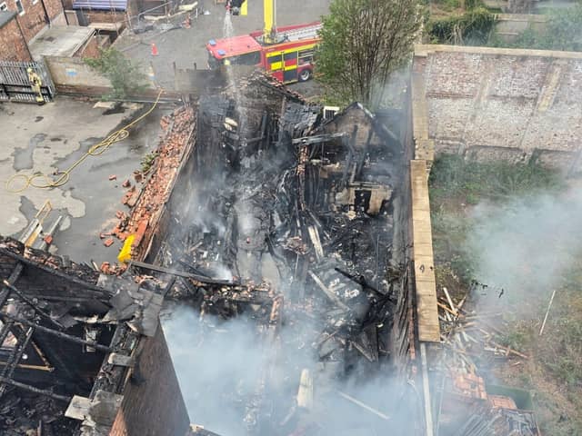 Firefighters remain on Barbauld Street in Warrington tackling a huge blaze which ripped through a derelict building.