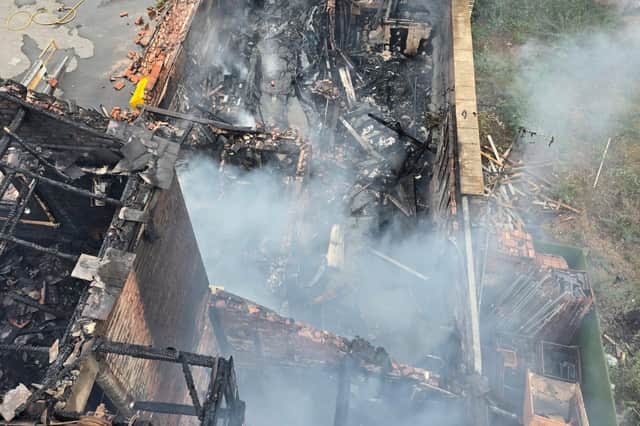 Firefighters remain on Barbauld Street in Warrington tackling a huge blaze which ripped through a derelict building.