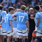 Pep Guardiola, Manager of Manchester City speaks with Kevin De Bruyne of Manchester City and  of Manchester City  during the Premier League match between Manchester City FC and Crystal Palace FC at Etihad Stadium on April 12, 2025 in Manchester, England. 