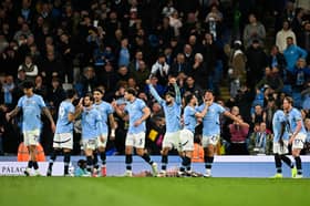 Manchester City's Portuguese midfielder #27 Matheus Nunes (3rd R) celebrates with teammates after scoring his team second goal during the English Premier League football match between Manchester City and Aston Villa at the Etihad Stadium in Manchester, north west England, on April 22, 2025. 