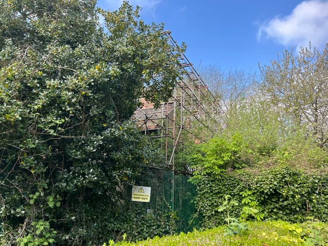The Watling Gate building can now hardly be seen because of the overgrown trees and shrubbery in its grounds