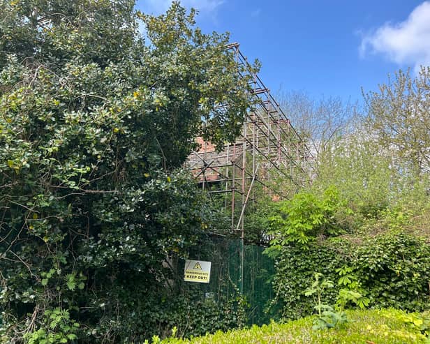 The Watling Gate building can now hardly be seen because of the overgrown trees and shrubbery in its grounds