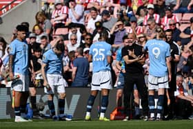 Pep Guardiola, Manager of Manchester City, gives instructions to Manuel Akanji of Manchester City, during a break in play in the Premier League match between Southampton FC and Manchester City FC at St Mary's Stadium on May 10, 2025 in Southampton, England.