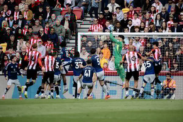 Altay Bayindir of Manchester United makes a save during the Premier League match between Brentford FC and Manchester United FC at Brentford Community Stadium on May 04, 2025 in Brentford, England as summer target Bryan Mbeumo watches on 