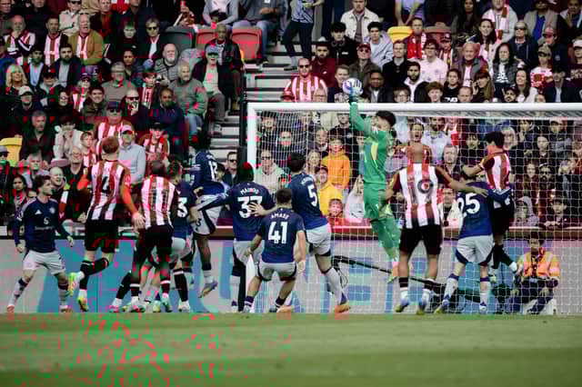 Altay Bayindir of Manchester United makes a save during the Premier League match between Brentford FC and Manchester United FC at Brentford Community Stadium on May 04, 2025 in Brentford, England as summer target Bryan Mbeumo watches on