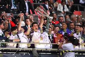 Luke O'Nien of Sunderland lifts The Sky Bet Championship Play-Off trophy after his team's victory and subsequent promotion to the Premier League following the Sky Bet Championship Play-Off Final match between Sheffield United and Sunderland at Wembley Stadium on May 24, 2025 in London, England. 
