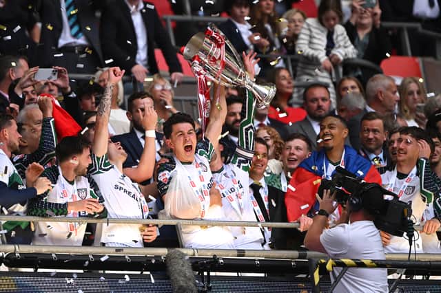 Luke O'Nien of Sunderland lifts The Sky Bet Championship Play-Off trophy after his team's victory and subsequent promotion to the Premier League following the Sky Bet Championship Play-Off Final match between Sheffield United and Sunderland at Wembley Stadium on May 24, 2025 in London, England.