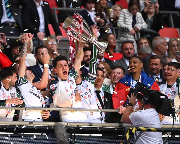 Luke O'Nien of Sunderland lifts The Sky Bet Championship Play-Off trophy after his team's victory and subsequent promotion to the Premier League following the Sky Bet Championship Play-Off Final match between Sheffield United and Sunderland at Wembley Stadium on May 24, 2025 in London, England. 