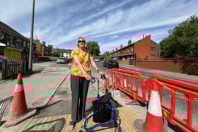 Linda Ellison standing on the new 'lump' she says makes it hard to move around. She is unhappy about a new bike lane being installed on St Helens Road in Leigh