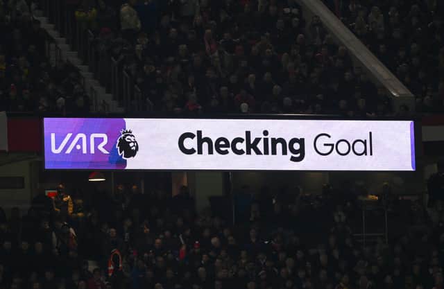 VAR Checking Goal sign is seen during the Premier League match between Manchester United FC and Newcastle United FC at Old Trafford on December 30, 2024 in Manchester, England.